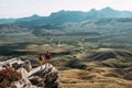 A man and a woman in tourist equipment are standing on a rock and admiring the panoramic view. Royalty Free Stock Photo