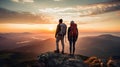 man and woman tourist hiking at mountain peak at sunset, romantic hikers couple standing at cliff at sunrise Royalty Free Stock Photo