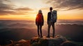 man and woman tourist hiking at mountain peak at sunset, romantic hikers couple standing at cliff at sunrise Royalty Free Stock Photo