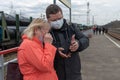 A man and a woman on a train platform