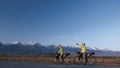 The man and woman travel on mixed terrain cycle touring with bikepacking. The couple journey with bicycle bags. Mountain