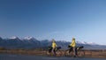 The man and woman travel on mixed terrain cycle touring with bikepacking. The couple journey with bicycle bags. Mountain Royalty Free Stock Photo