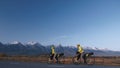 The man and woman travel on mixed terrain cycle touring with bikepacking. The couple journey with bicycle bags. Mountain Royalty Free Stock Photo