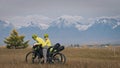 The man and woman travel on mixed terrain cycle touring with bikepacking. The love couple journey with tent in with