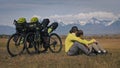 The man and woman travel on mixed terrain cycle touring with bikepacking. The two people journey with bicycle bags Royalty Free Stock Photo