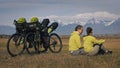 The man and woman travel on mixed terrain cycle touring with bikepacking. The two people journey with bicycle bags Royalty Free Stock Photo