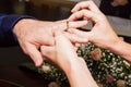 Man and woman tuck each other on the ring finger at registry office at a wedding Royalty Free Stock Photo