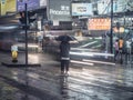 A man and woman under umbrella in Hong Kong rain Royalty Free Stock Photo