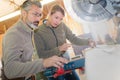 Man and woman using circular saw Royalty Free Stock Photo