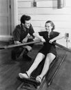 Man with woman using rowing machine Royalty Free Stock Photo