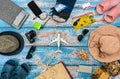 Man and woman vacation accessories on the blue wooden boards. Plane in center Royalty Free Stock Photo