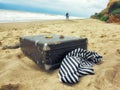 Man and woman in walk on the sand along the sea, frock valise Royalty Free Stock Photo