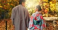 Man, woman and walking in forest with date in nature park, back of couple in traditional clothes in Japan. Love, care