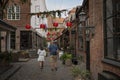 Man and woman walking in an old decotared street in the shopping center of Odense Royalty Free Stock Photo