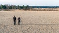 Man and woman walking in a sandy Dutch nature reserve