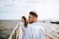 Man and woman walking on the sea pier. Summer vacation Royalty Free Stock Photo