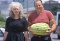 Man and woman walking with watermelon, St. Louis, MO