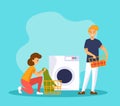 Man and woman wash clothes in a washing maching. Couple doing laundry. Family housework. Royalty Free Stock Photo
