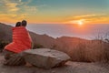 Man and woman Watch Sunset while under sleeping bag Royalty Free Stock Photo