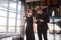 Man and woman wearing face masks preparing for departure Royalty Free Stock Photo