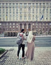 A man and a woman wearing a hijab on a central street in Kiev look at preparations for the celebration
