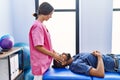 Man and woman wearing physiotherapist uniform having reiki session at physiotherpy clinic Royalty Free Stock Photo