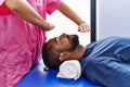 Man and woman wearing physiotherapist uniform having reiki session at physiotherpy clinic Royalty Free Stock Photo