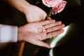 Man and woman with wedding rings in open hands and wedding bouquet. Exchange rings. happy groom and bride. Wedding day concept Royalty Free Stock Photo