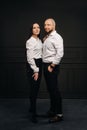 A man and a woman in white shirts on a black background.A couple in love in the studio interior Royalty Free Stock Photo