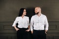 A man and a woman in white shirts on a black background.A couple in love in the studio interior Royalty Free Stock Photo