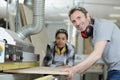 man and woman workers in carpentry workshop Royalty Free Stock Photo