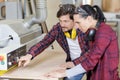 man and woman workers in carpentry workshop