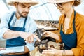 Man and woman working on the farm for snails growing Royalty Free Stock Photo