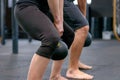 Man and woman working out with kettle weights