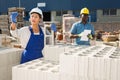 Man and woman working in outdoor construction material storage