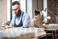 Man and woman working in the pottery shop Royalty Free Stock Photo