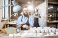 Man and woman working in the pottery shop Royalty Free Stock Photo