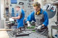 Man and woman working together in metal workshop