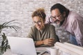 Man and woman working together in the office with laptop and papers projects. Modern busines and e-commerce job lifestyle. Happy Royalty Free Stock Photo