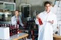 Man and woman working on wine production