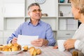 Man and woman 50-54 years old are discussing and studying important contract Royalty Free Stock Photo