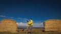 Man and woman in yellow green sportswear. Lovely couple of travelers hug and kiss near old stone enjoying highland Royalty Free Stock Photo