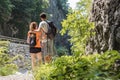 Man and woman hiking on the steep path above the mountain river