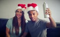 Man and women chritmas party sitting drinking celebrate relationship together young couple wearing red hat