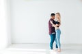 beautiful man and woman dancing bachata to music in a white room