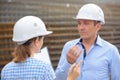 Man and woman in discussion on construction site