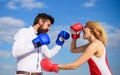 Man and woman fight boxing gloves blue sky background. Defend your opinion in confrontation. Couple in love fighting