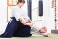 Man and woman fighting at Aikido martial arts school Royalty Free Stock Photo