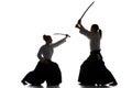 Man and woman fighting and training aikido on white studio background