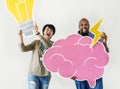 Man and woman holding light bulb and pink cloud icons Royalty Free Stock Photo